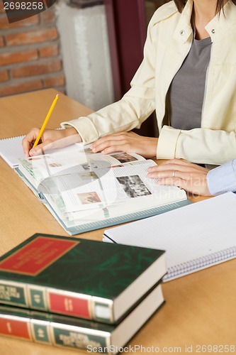 Image of Students Studying At Table In Library