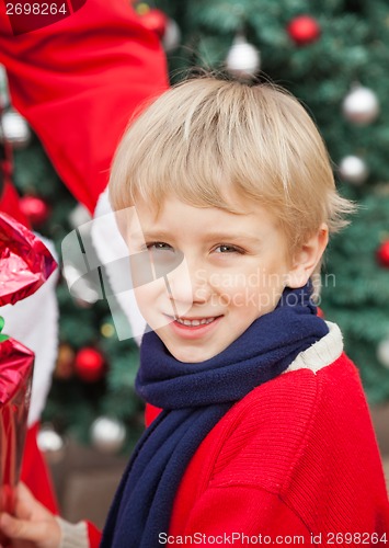 Image of Cute Boy Receiving Gift From Santa Claus