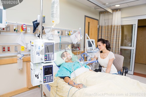 Image of Worried Woman Looking At Critical Patient