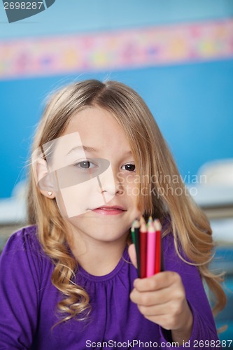 Image of Girl Holding Bunch Of Color Pencils In Preschool