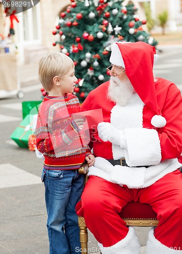 Image of Boy Giving Wish List To Santa Claus