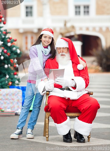 Image of Girl With Santa Claus Using Digital Tablet