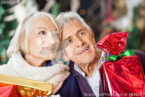 Image of Couple With Christmas Presents In Store