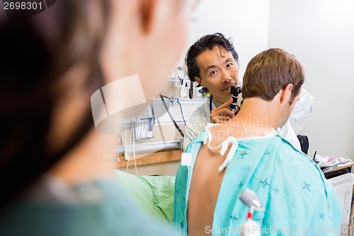 Image of Doctor With Otoscope Examining Patient's Ear In Hospital