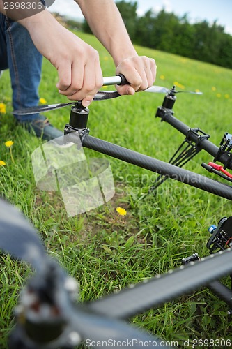 Image of Engineer Fixing Propeller Of UAV Helicopter