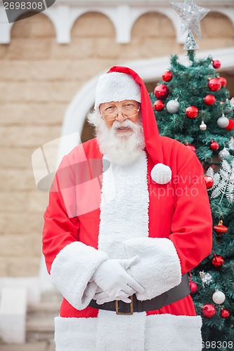 Image of Santa Claus Against Christmas Tree