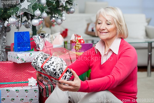 Image of Senior Woman Looking At Christmas Gift