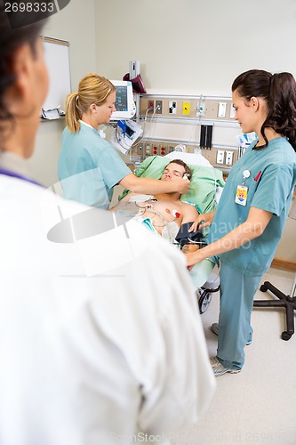Image of Nurses And Doctor Treating Critical Patient