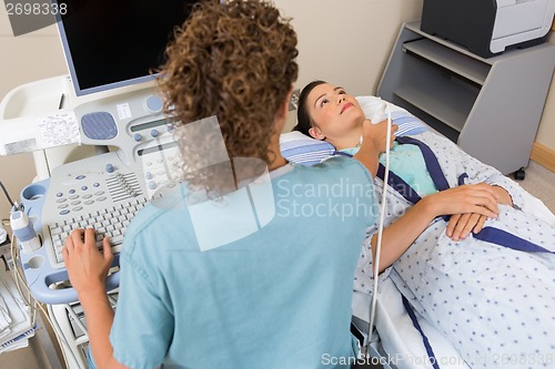 Image of Nurse Performing Ultrasound Scan On Patient's Neck