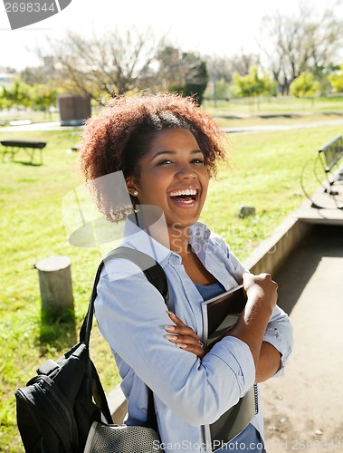 Image of Cheerful Woman Standing Hands Folded On Campus