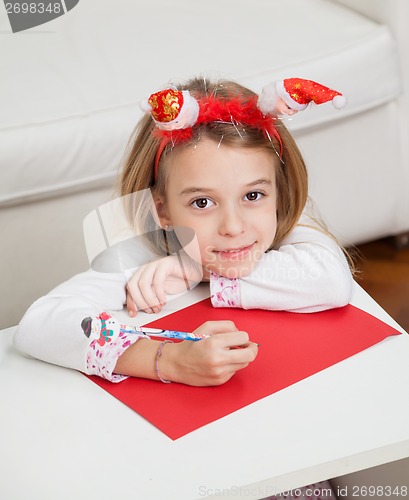 Image of Girl Making Christmas Greeting Card