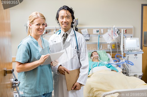 Image of Nurse And Doctor Examining Patient's Report