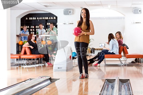 Image of Woman Holding Ball in Bowling Alley