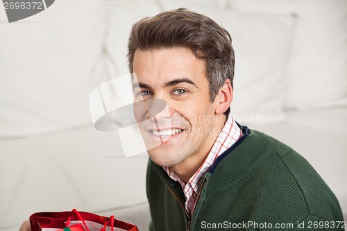 Image of Man Smiling At Home During Christmas