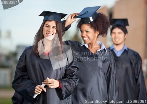 Image of Confident Student Holding Certificate On College Campus