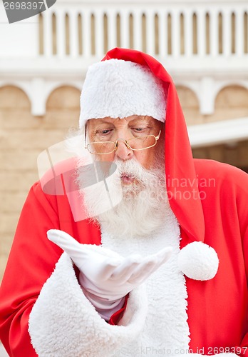 Image of Santa Claus Blowing In Palm