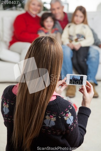Image of Mother Photographing Family Through Smartphone