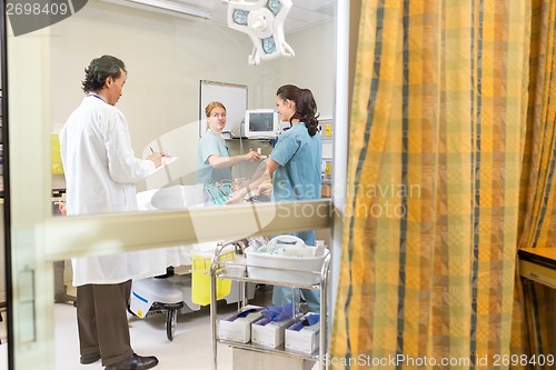 Image of Doctor And Nurses Treating Patient