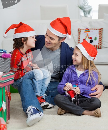 Image of Loving Father With Siblings During Christmas