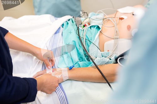 Image of Nurse Attaching IV Solution On Patient's Hand