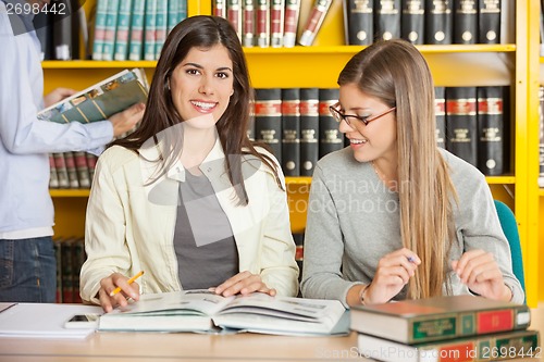 Image of Female Student With Friend Sitting In University Library