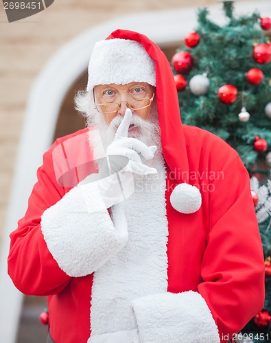 Image of Santa Claus Gesturing Finger On Lips