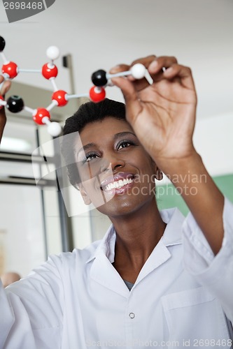 Image of Female Teacher Examining Molecular Structure