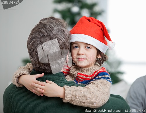 Image of Son Embracing Father During Christmas