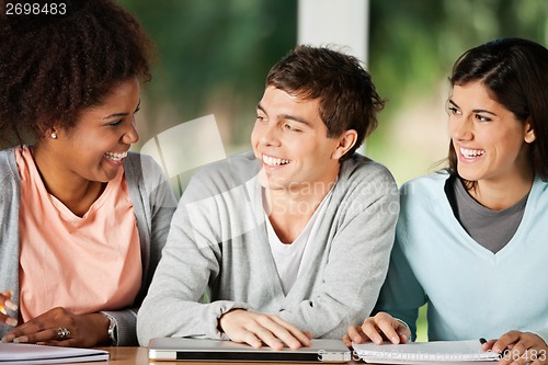 Image of Students With Books And Laptop Looking At Classmate In Classroom