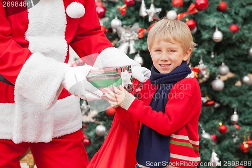Image of Boy Taking Present From Santa Claus