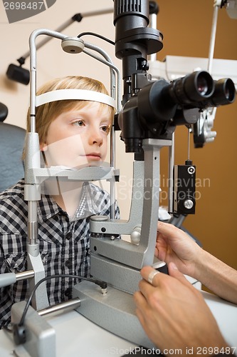 Image of Boy Having His Eyes Examined With Slit Lamp By Doctor