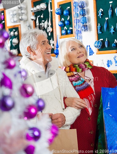 Image of Senior Couple Shopping At Christmas Store