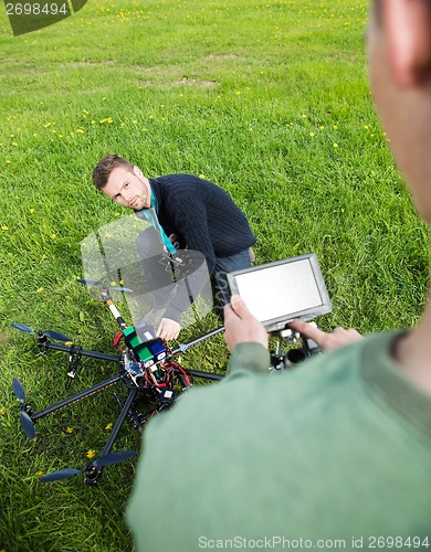 Image of Engineers Working On UAV Helicopter At Park