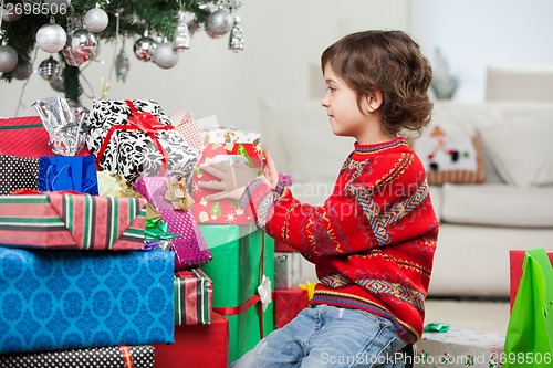 Image of Boy Stacking Christmas Presents