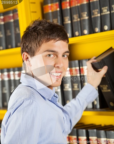 Image of Handsome Student Choosing Book From Shelf In Library