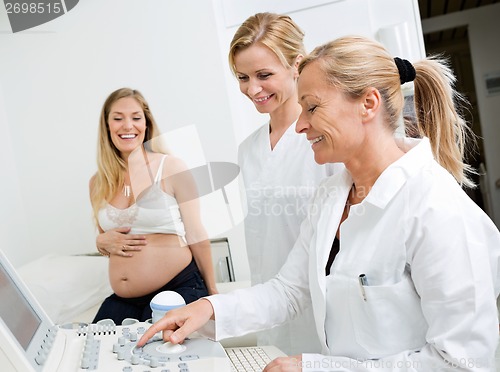 Image of Technicians Using Ultrasound Machine In Clinic