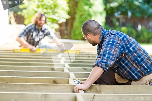 Image of Carpenters Working At Construction Site