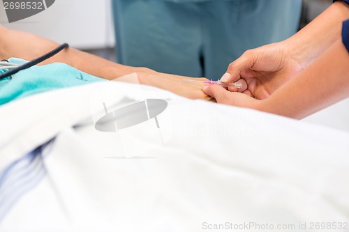 Image of Nurse Inserting Needle In Patient's Nerve At Hospital