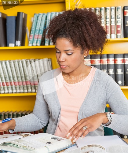Image of Student With Books Studying At Table In Library