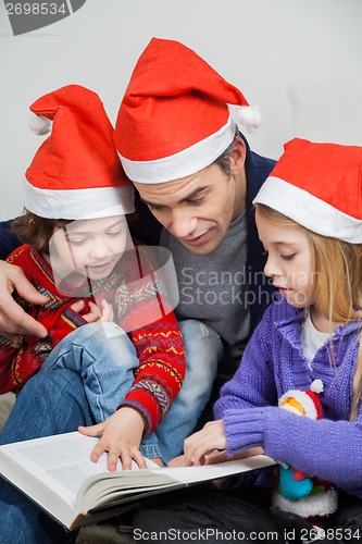 Image of Children And Father Reading Book