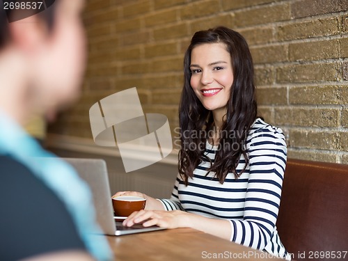 Image of Attractive Woman Sitting With Laptop At Table