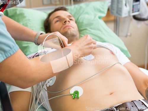 Image of Nurse Sticking Holter On Patient's Chest In Hospital