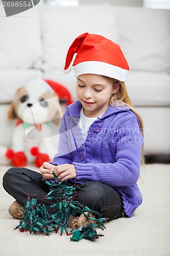 Image of Girl With Fairy Lights During Christmas