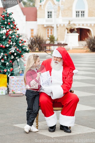 Image of Girl Showing Wish List To Santa Claus
