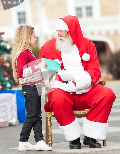 Image of Santa Claus Taking Letter From Girl