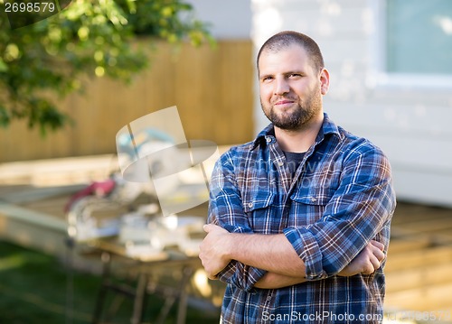 Image of Manual Worker With Arms Crossed Standing At Construction Site