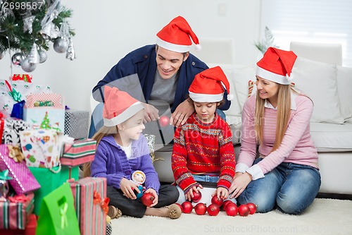 Image of Family With Christmas Decorations And Gifts