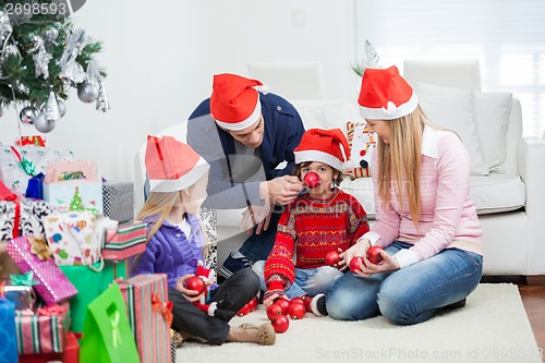 Image of Family With Christmas Gifts And Ornaments