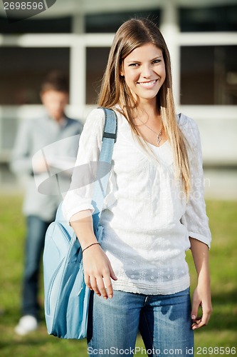 Image of University Student Carrying Shoulder Bag Standing On Campus