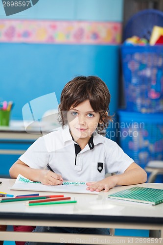 Image of Boy With Sketch Pen Drawing In Classroom